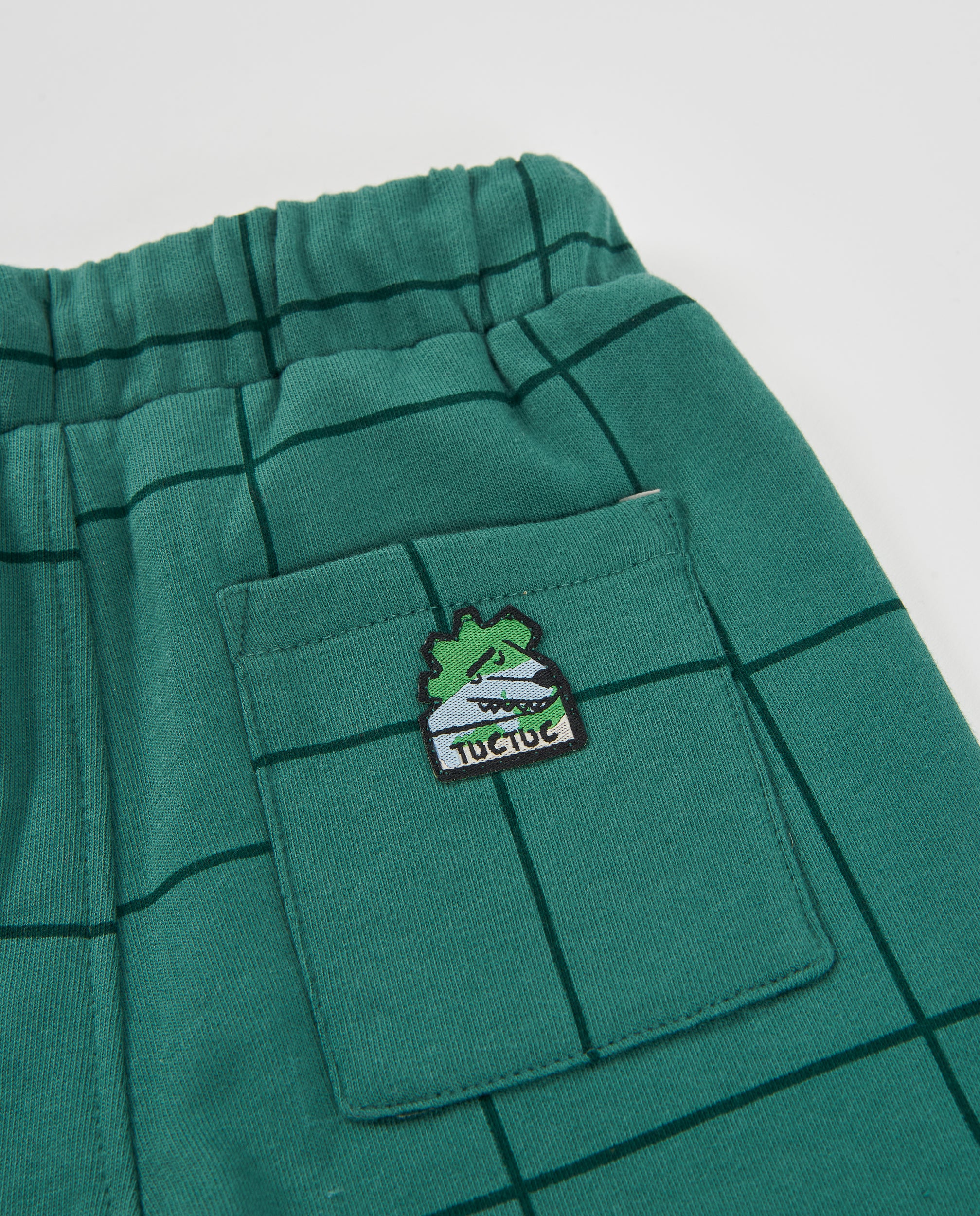 Pantalón de niño de felpa con diseño de cuadros y cordón