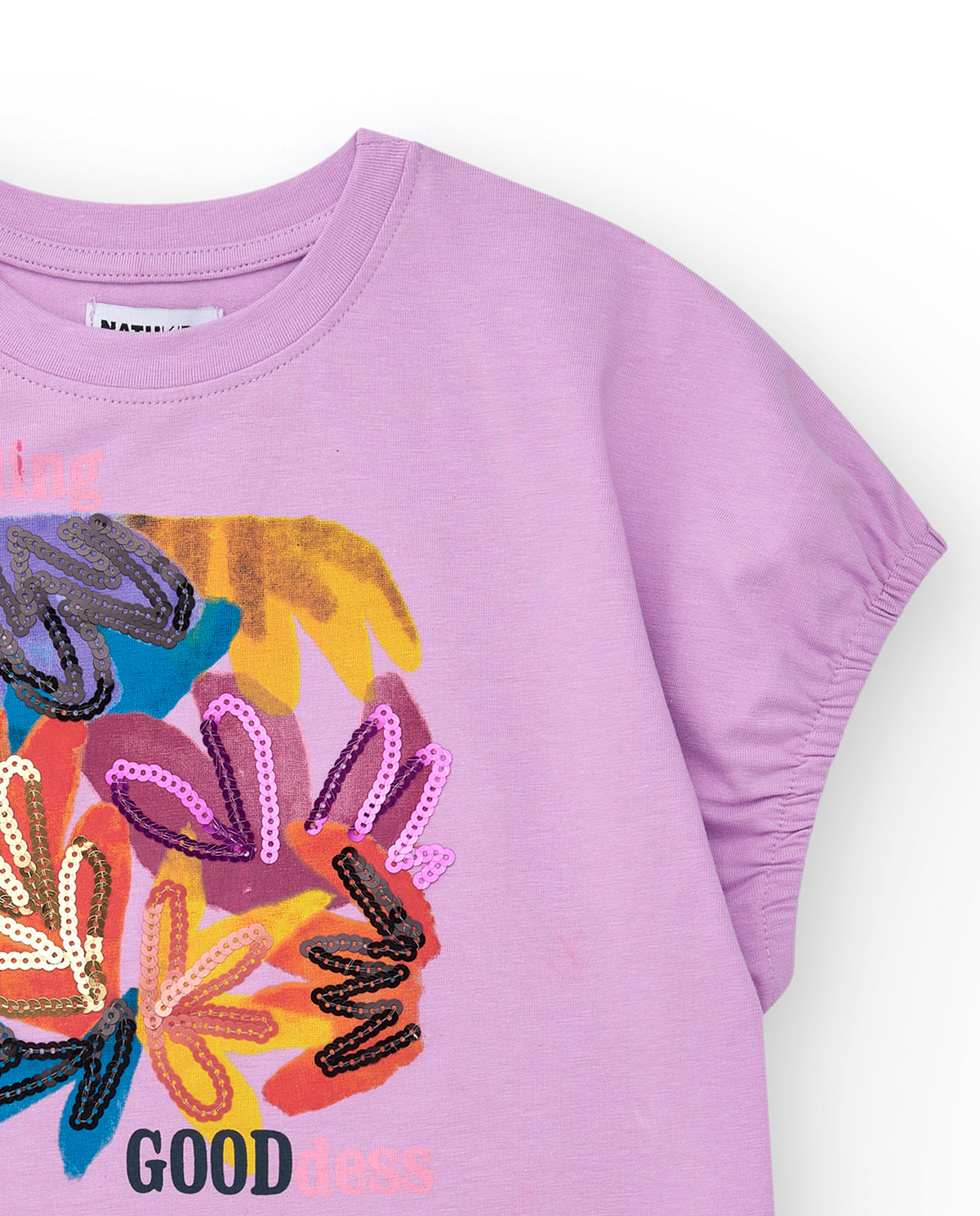 Camiseta para niña en lila con lentejuelas y dobladillo curvo