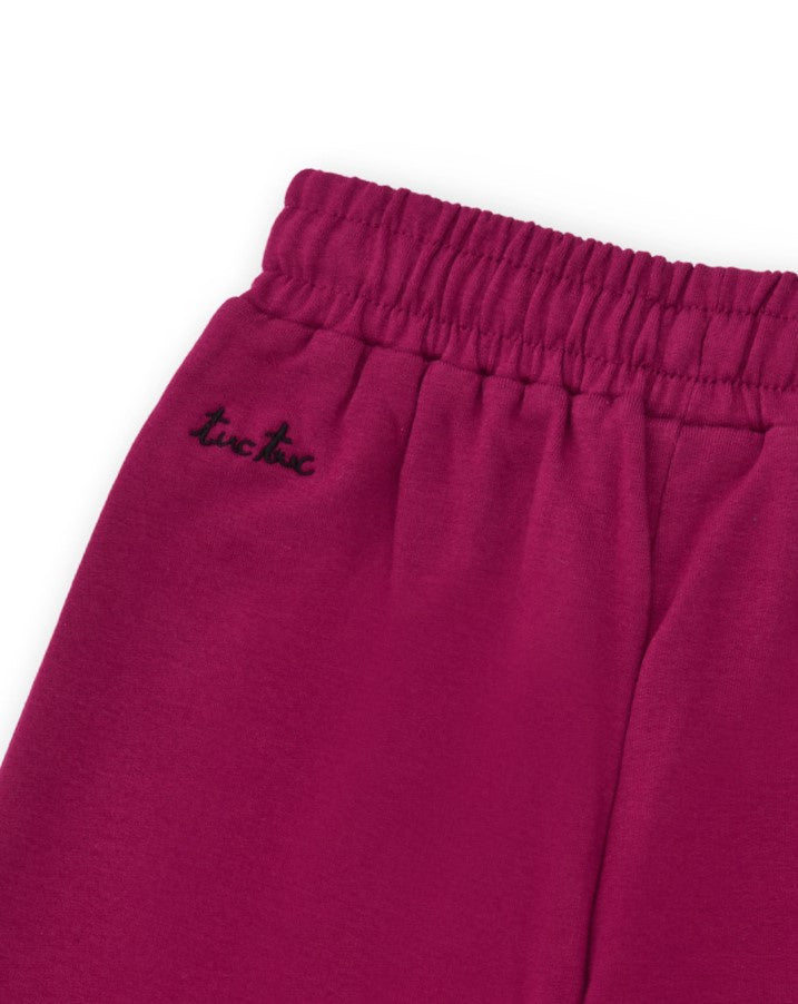 Pantalón ancho de niña en color fucsia con lazo brillante
