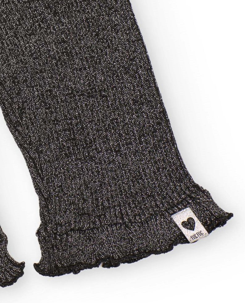 Pantalón de punto para niña en gris con volante en el bajo