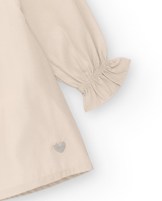 Vestido de niña en beige con lazo decorativo