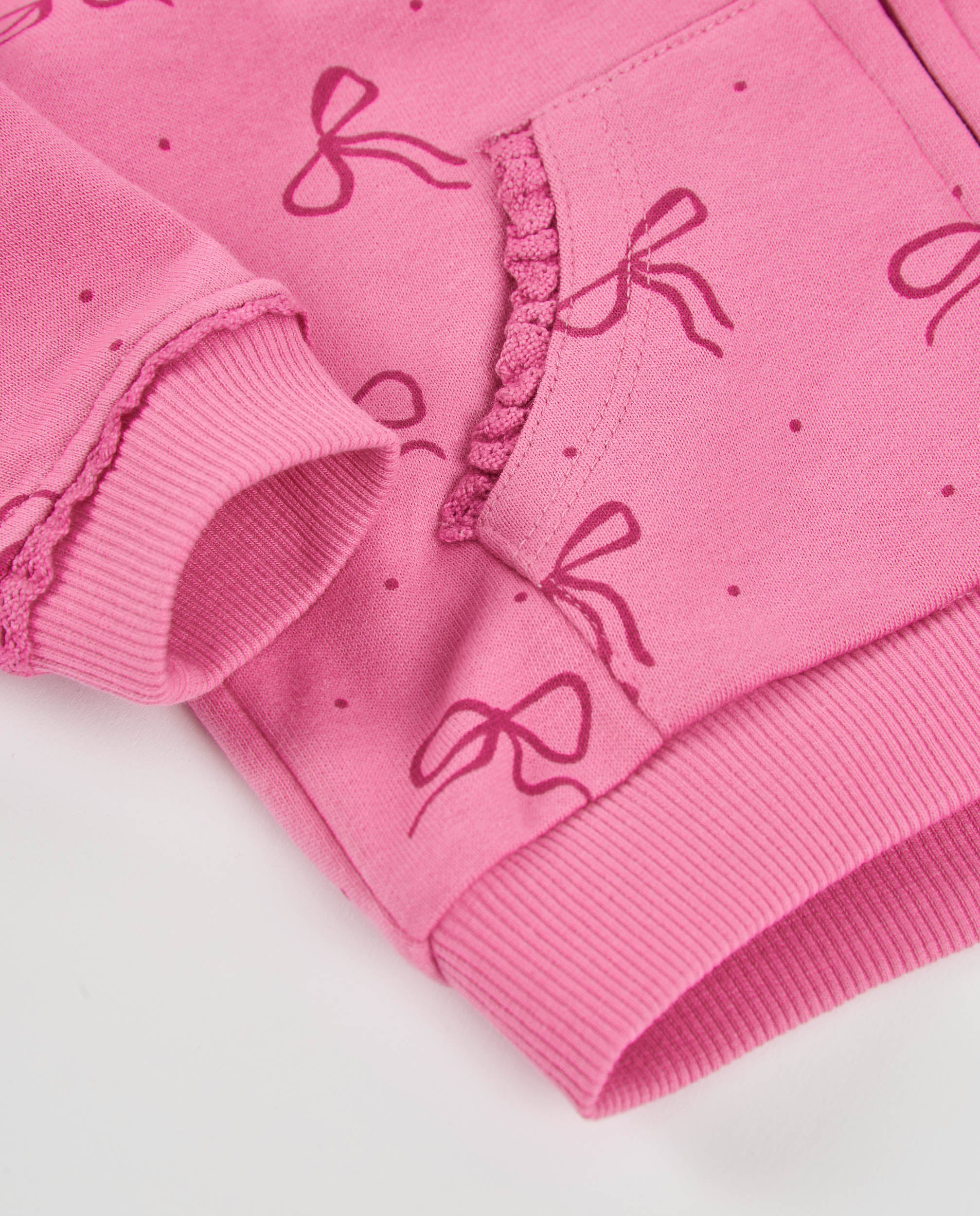 Sudadera de niña de felpa con capucha y cremallera y diseño de lazos