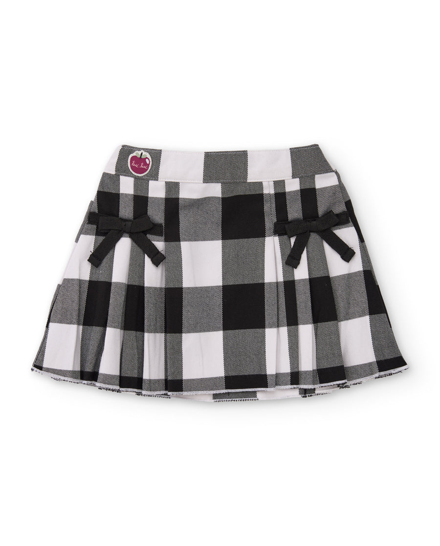 Girls' plain-weave skirt with a checked print and bows