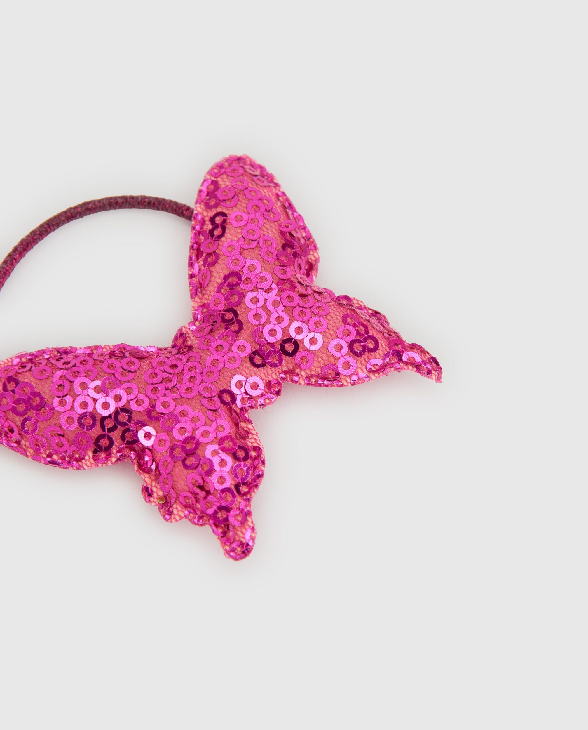 Coletero de niña con mariposa de lentejuelas y detalles brillantes