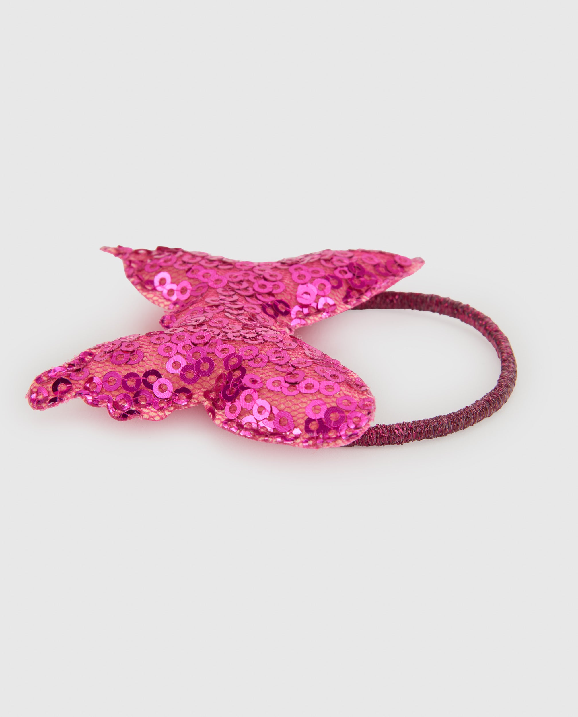 Coletero de niña con mariposa de lentejuelas y detalles brillantes