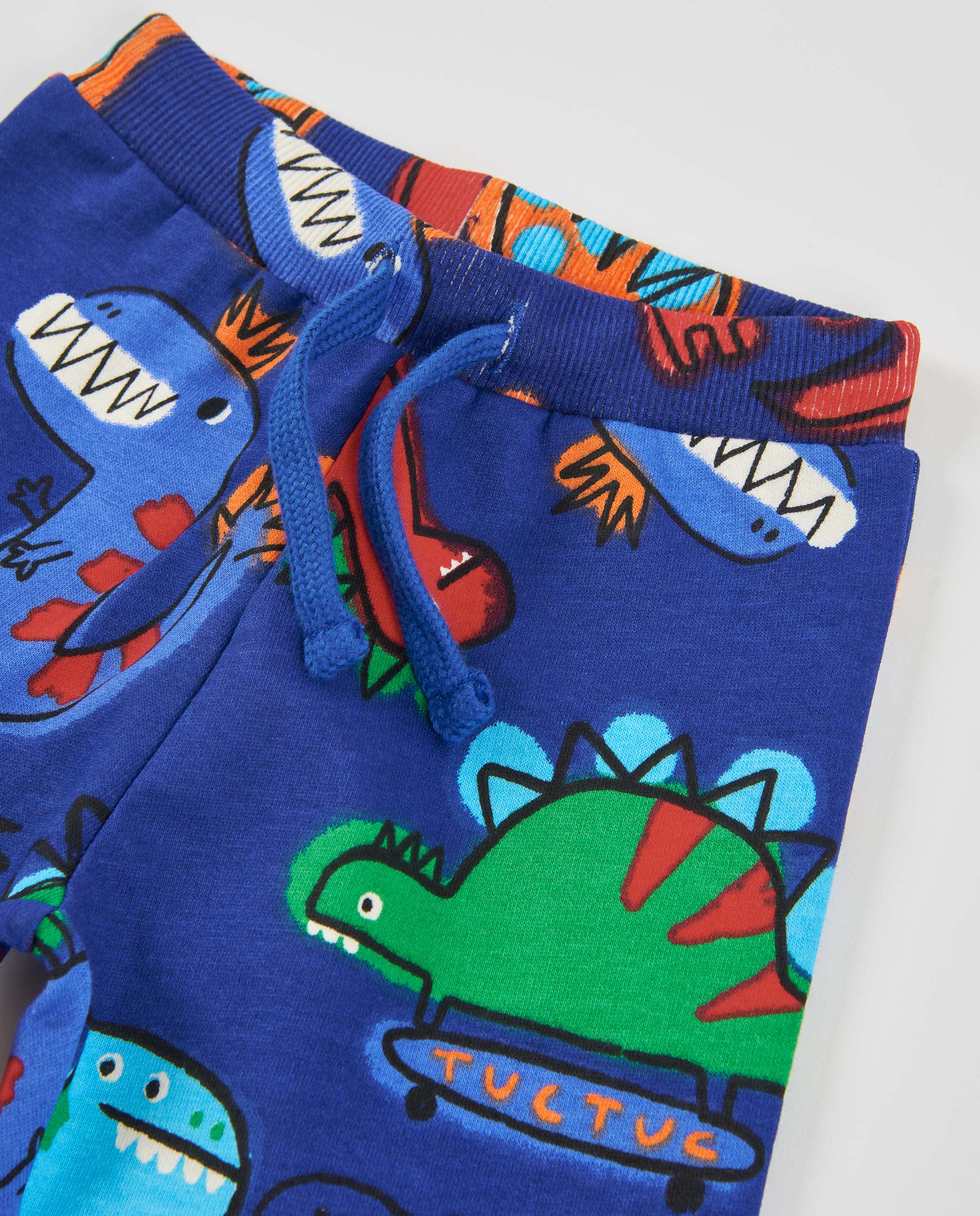 Pantalón de niño de felpa con print de dinosaurios y tejido resistente