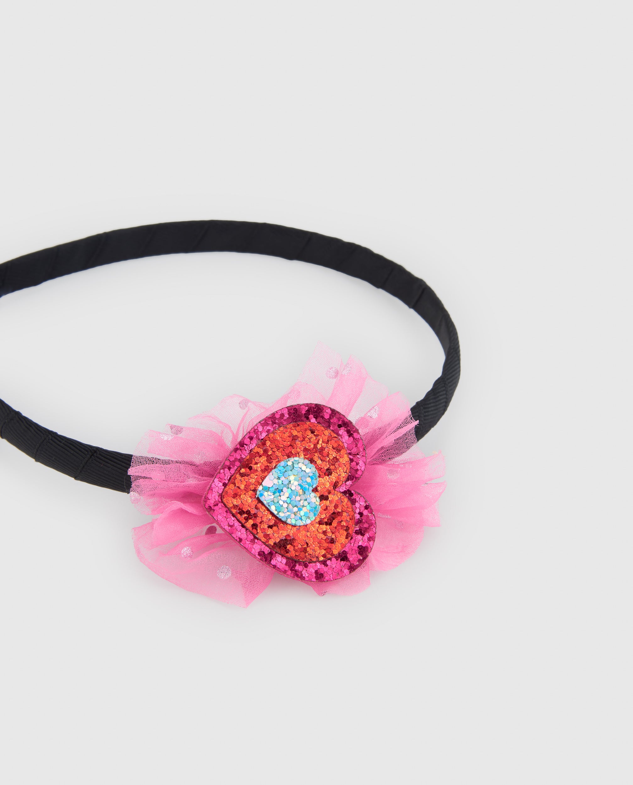 Diadema de niña rígida con adorno de corazón y diseño elegante