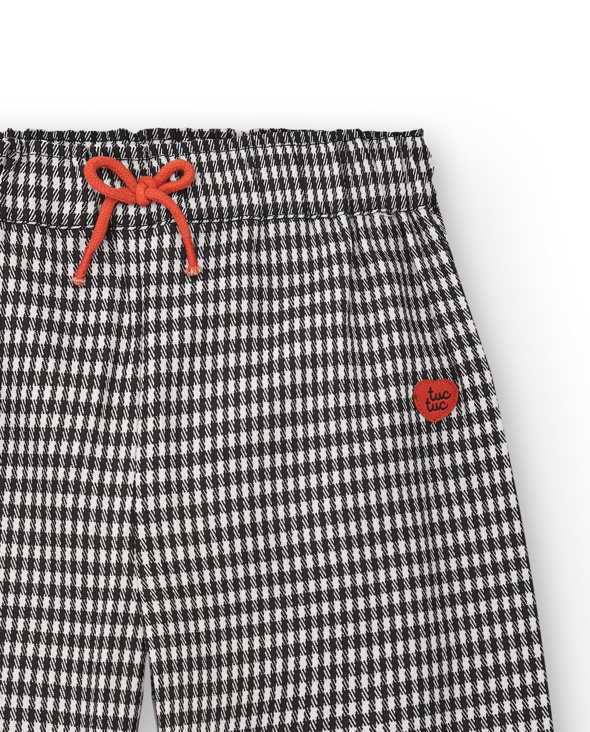 Pantalón de cuadros vichy en blanco y negro con lazo rojo para