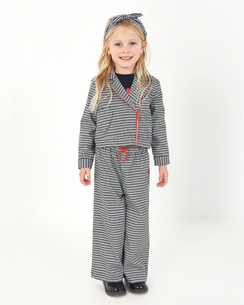 Pantalón de cuadros vichy en blanco y negro con lazo rojo para