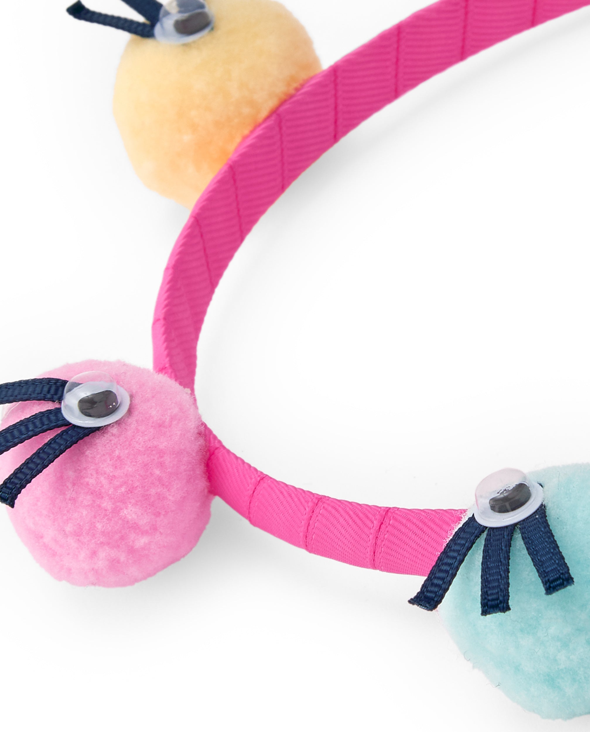 Diadema para niña color rosa con pompones multicolor y ojos