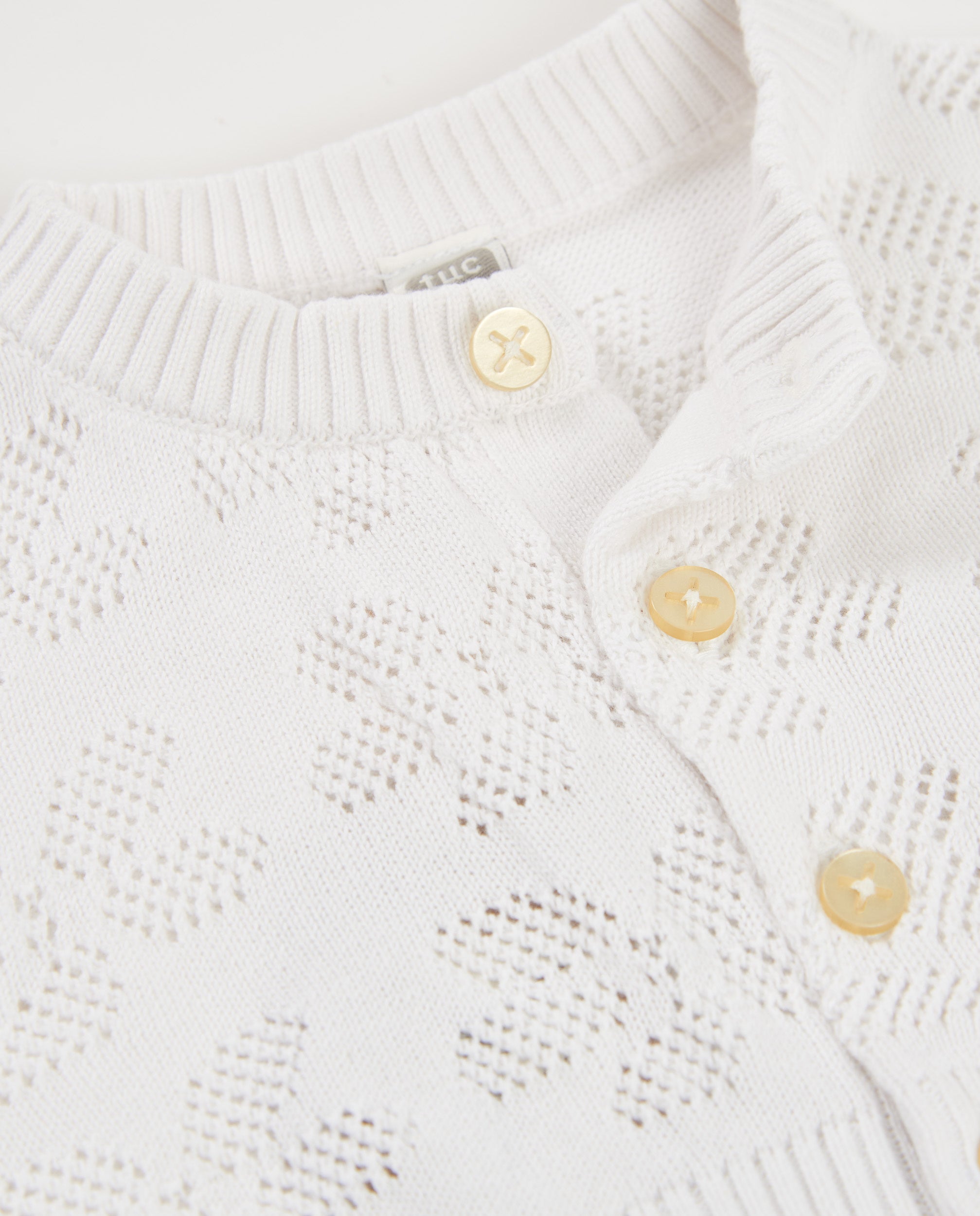Chaqueta de niña de tricot y diseño calado