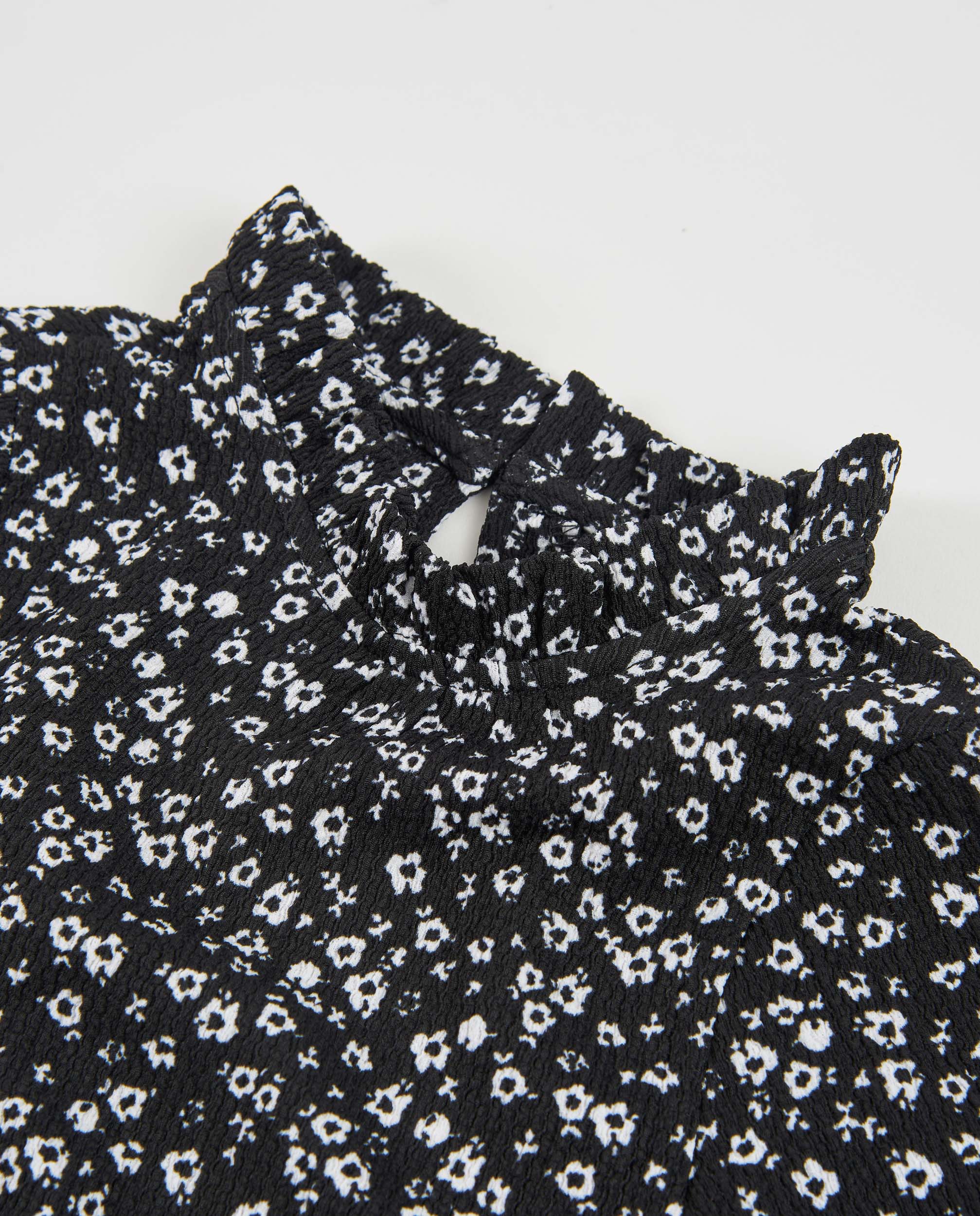 Blusa de niña de tela plana con cuello alto y estampado floral