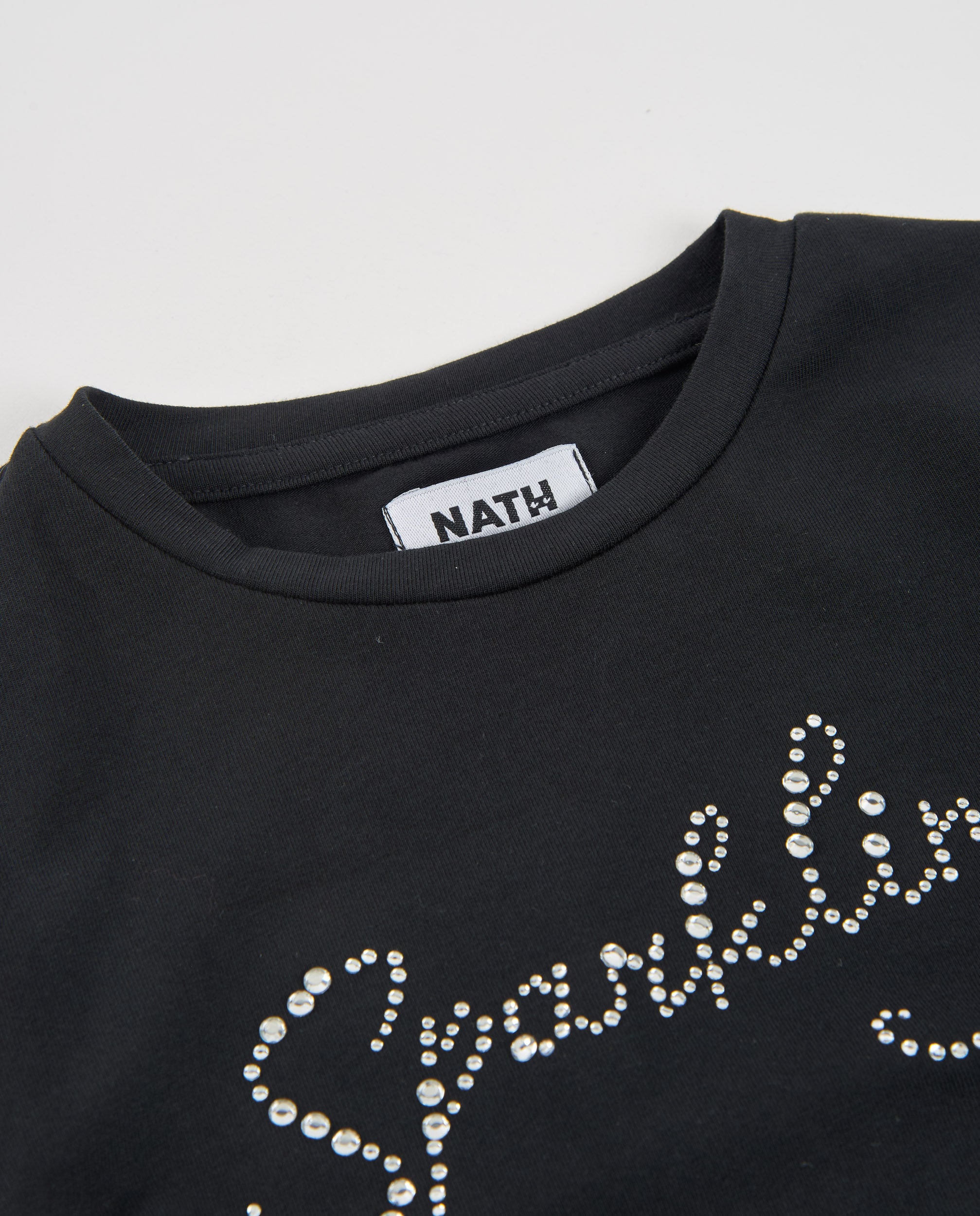 Camiseta de niña de punto con detalles brillantes y corte asimétrico