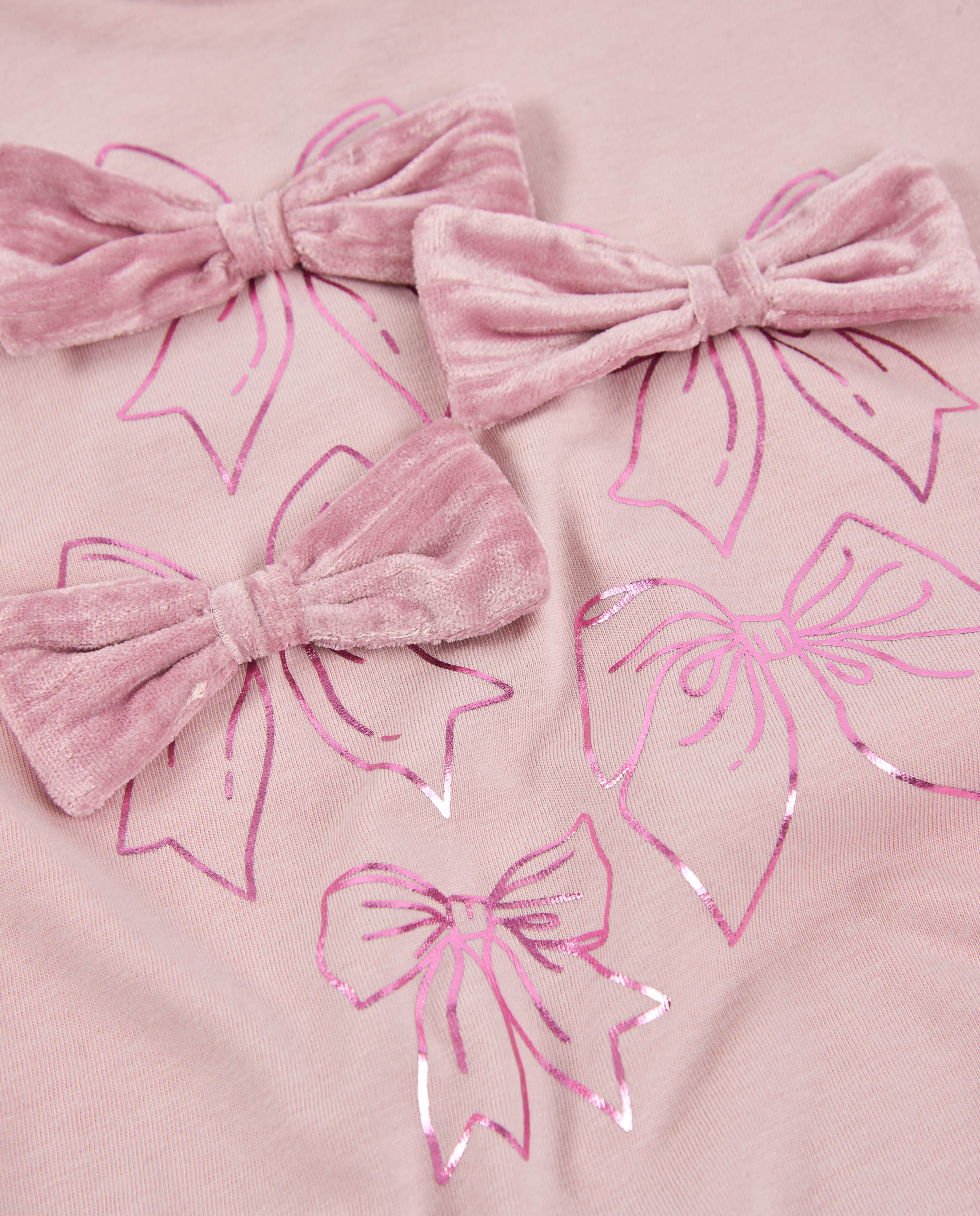 Camiseta de niña de punto con lazos en el pecho y manga larga