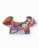 Girls' outfit with a short shirt and skirt in orange and blue with a floral print.