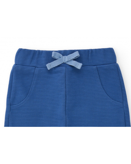 Three-piece baby boy outfit in blue and white tones with bird details