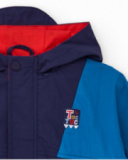 Windbreaker jacket for boy with navy and electric blue color blocks and red hood.
