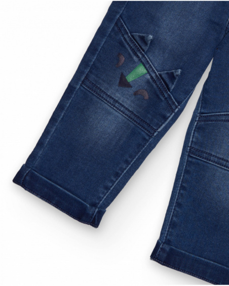 Boys' blue denim pants with dinosaur embroidery.