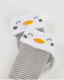 Knit socks for newborn in gray stripes with white cuff and penguin detail