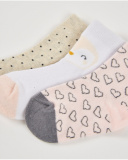 "Set of three pairs of socks for newborn in beige, white, and pink tones with assorted prints."