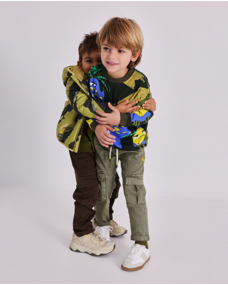 Green sweatshirt for boys with print of creatures in vibrant colors.