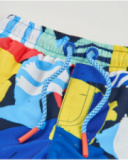 Boys swim shorts in plain weave fabric with an abstract style