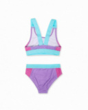 Purple sports bikini girl Paradiso beach