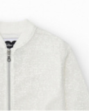 Girls' jacket in white with sequins and a front zipper closure.