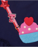 Girl’s outfit with navy blue t-shirt featuring purse appliqué and multicolored printed leggings. Girl’s outfit with navy blue t-shirt featuring purse appliqué and multicolored printed leggings.
