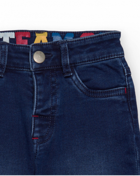 Blue children's denim pants with pockets and contrasting details. Blue children's denim pants with pockets and contrasting details.
