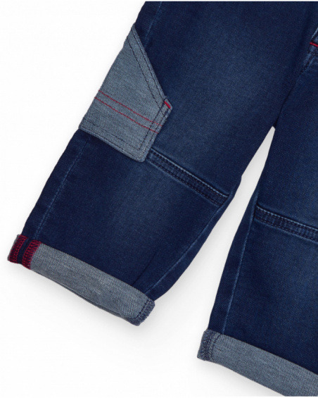 Blue children's denim pants with pockets and contrasting details. Blue children's denim pants with pockets and contrasting details.
