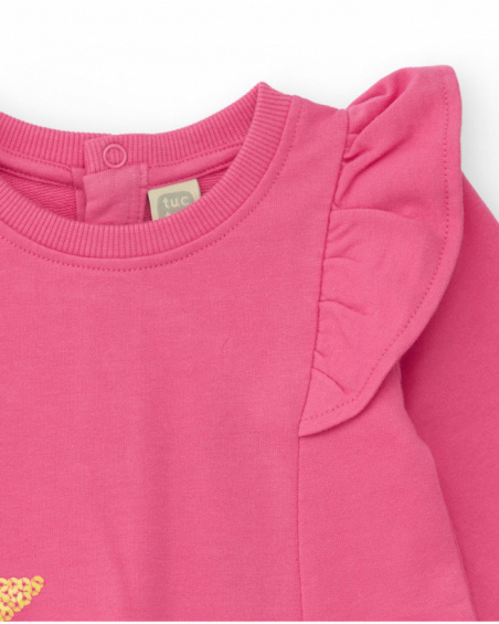 Pink knit dress for girl with star appliqués and shoulder ruffles.