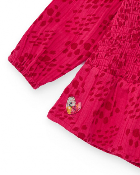 Girls' fuchsia blouse with smocking (honeycomb) detail.