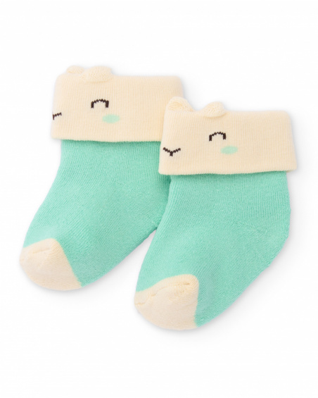 Socks for newborn in green and cream with smiley face design.