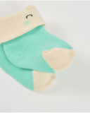 Baby boy socks in green and cream with smiling face design Baby boy socks in green and cream with smiling face design