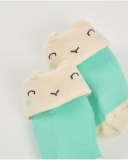 Baby boy socks in green and cream with smiling face design Baby boy socks in green and cream with smiling face design