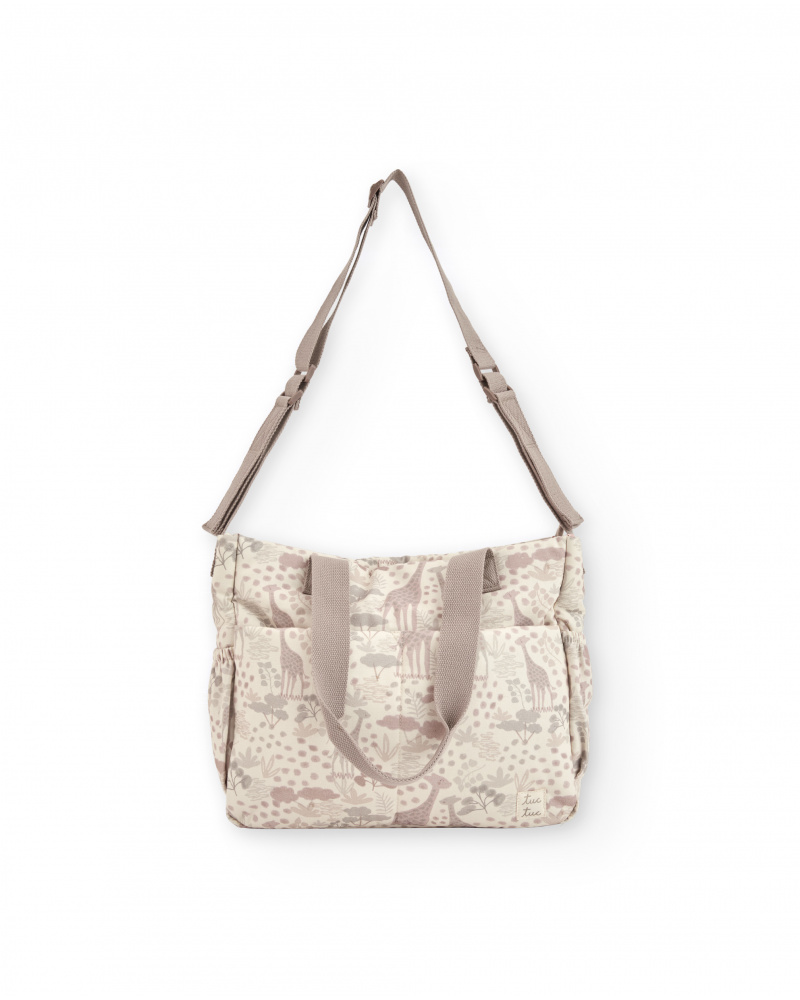 Baby changing bag with giraffe print in neutral tones