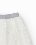 Falda para niña en blanco con lentejuelas y cintura elástica Falda para niña en blanco con lentejuelas y cintura elástica