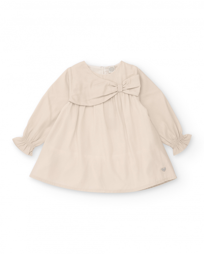 Vestido de niña en beige con lazo decorativo
