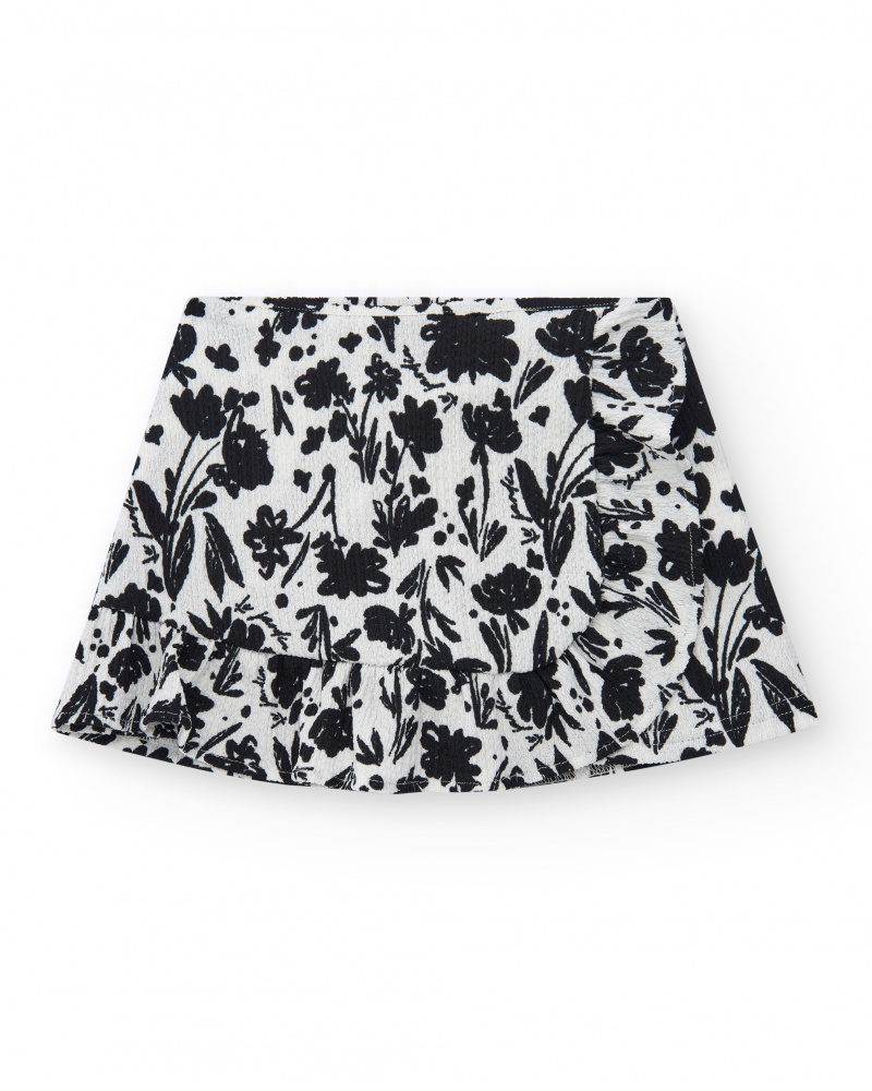 Jupe pour fille en blanc avec imprimé floral et volant.