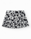 Jupe pour fille en blanc avec imprimé floral et volant.