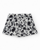 Jupe pour fille en blanc avec imprimé floral et volant.