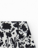 Jupe pour fille en blanc avec imprimé floral et volant.