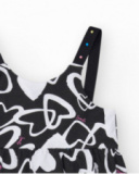 Robe pour fille en noir avec bretelles ajustables et appliques.