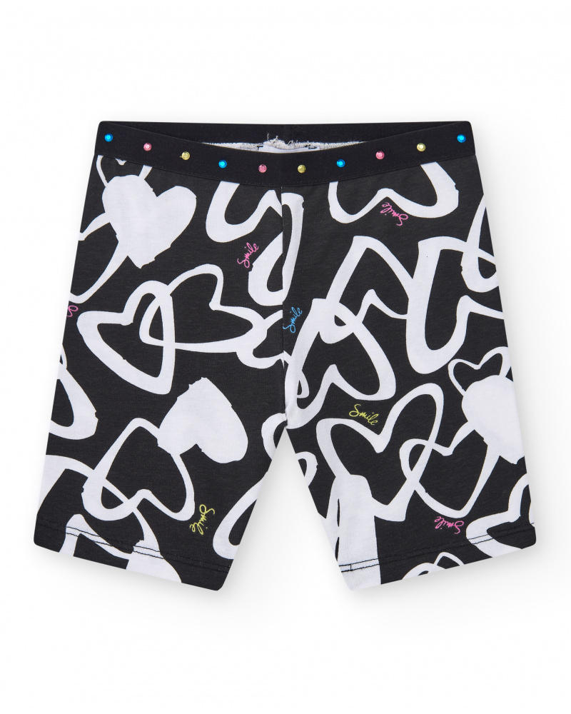 Legging cycliste pour fille en noir avec cœurs imprimés et taille décorée de clous.
