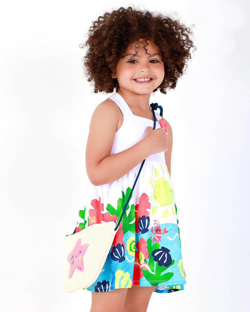 Robe blanche pour fille avec bretelles croisées et jupe fleurie