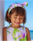 Diadema para niña en tonos lilas con lazo decorativo.