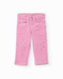 Pantalon long en sergé stretch pour fille couleur rose avec imprimé de petites étoiles dorées.
