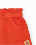 Short naranja para niña con lazo y bolsillos laterales