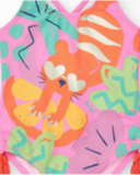 Bañador rosa para niña con estampado tropical y borlas laterales